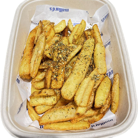 Bowl of seasoned French fries on a white background